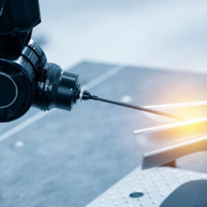 A person is using a machine to cut metal.